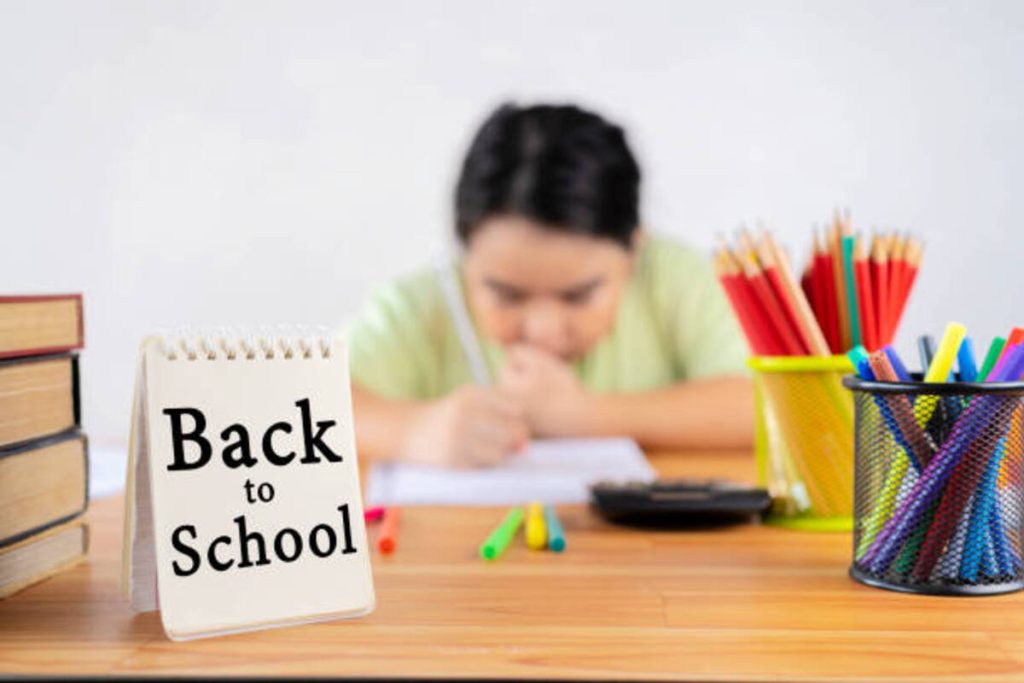 back to school concept an asian girl is doing her homework