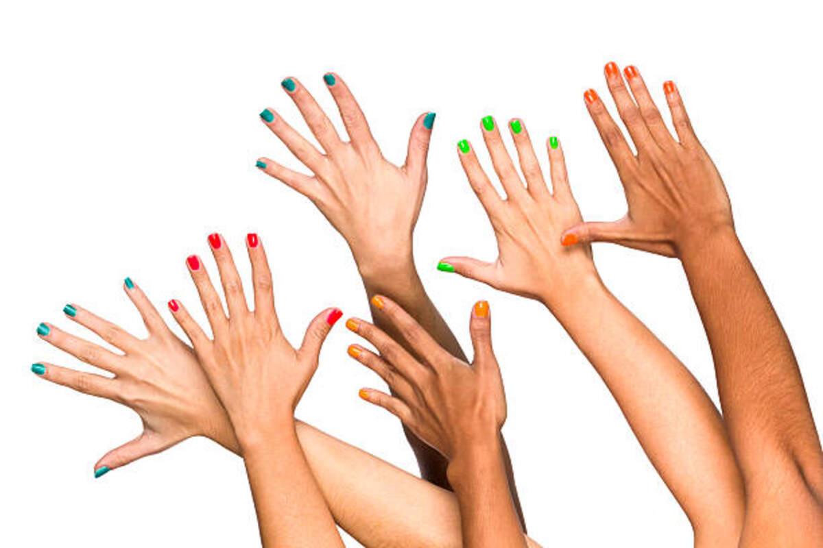 group of raised multiethnics female hands with colored manicure